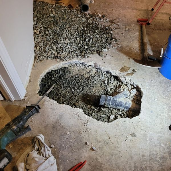 Drain cleaning plumber in Halifax clearing a clogged drain